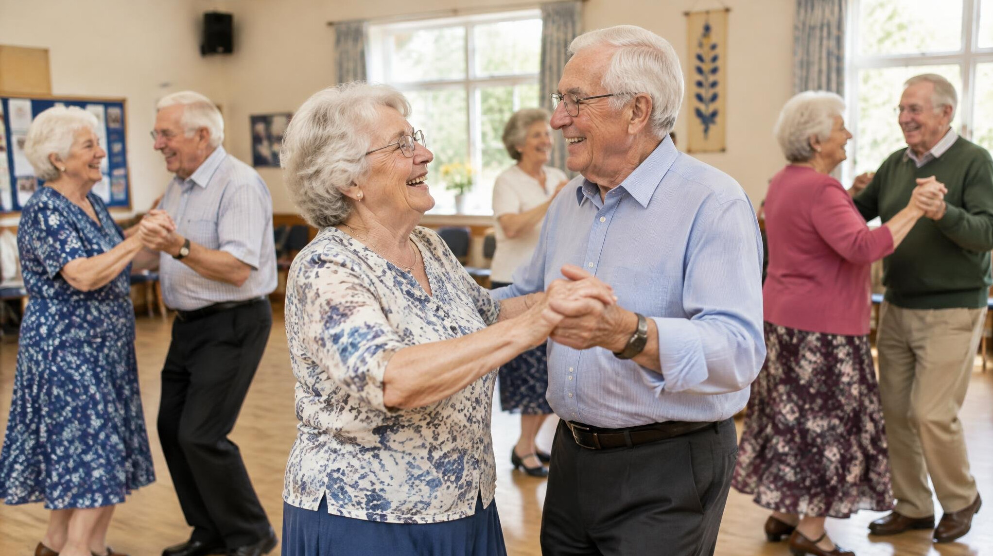 Group of elderly European people dancing together in a community hall